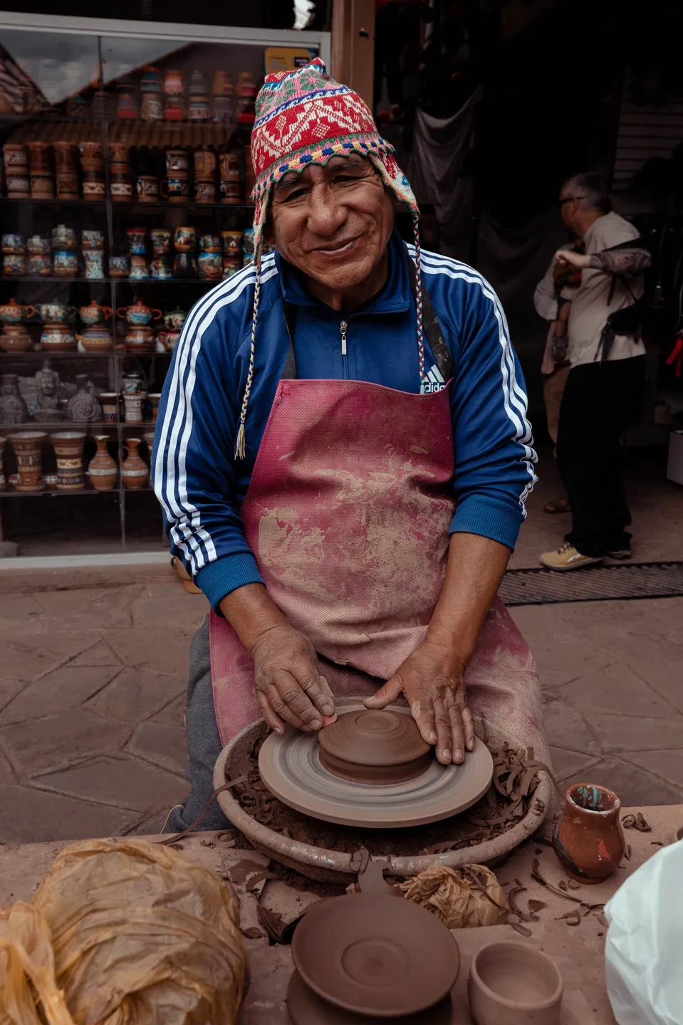 A person is making pottery on the potter 's wheel.