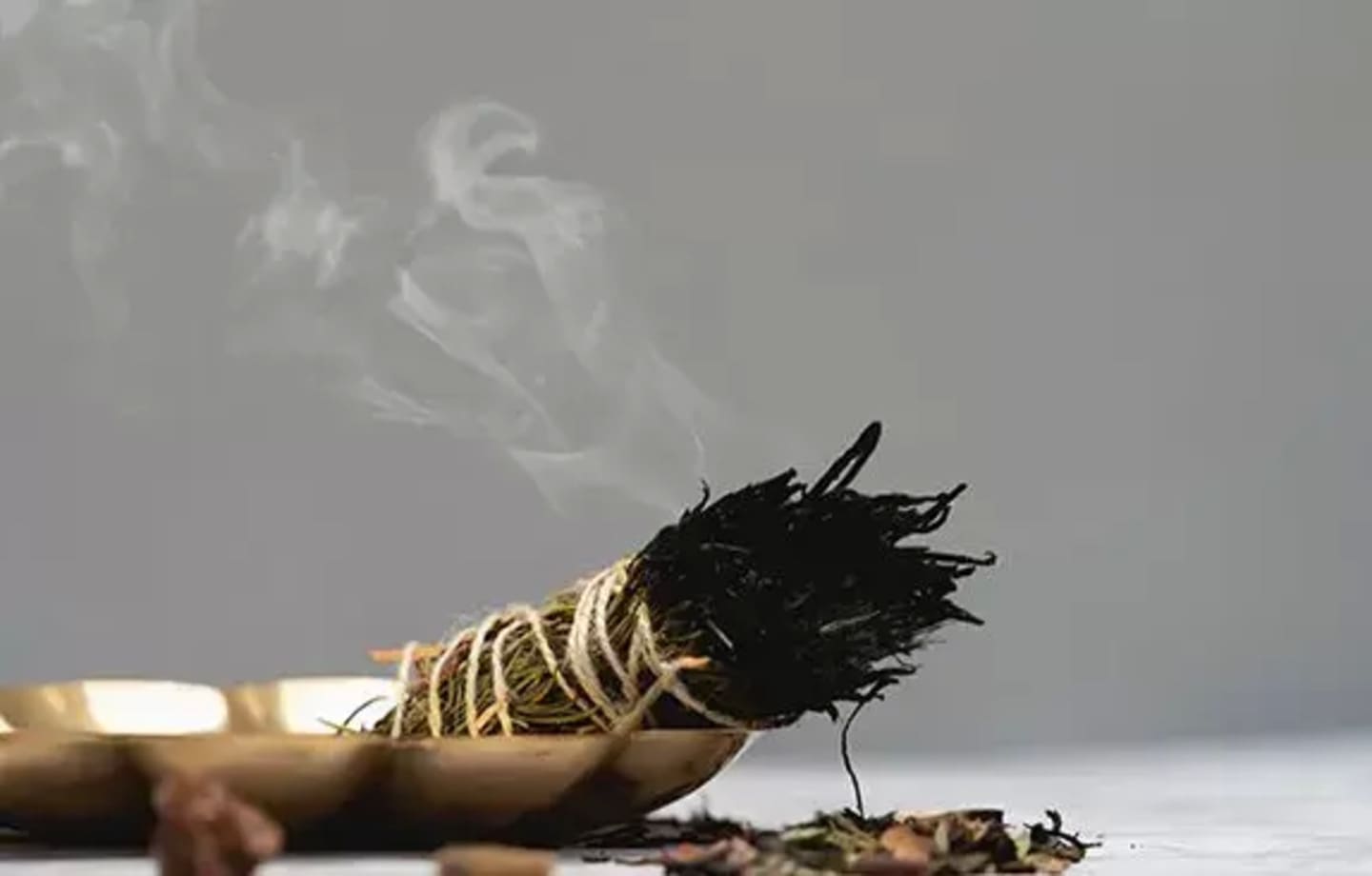 A close up of a burning stick with smoke coming out