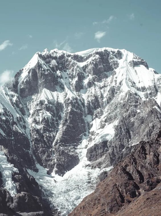 A large mountain with snow on it's side.