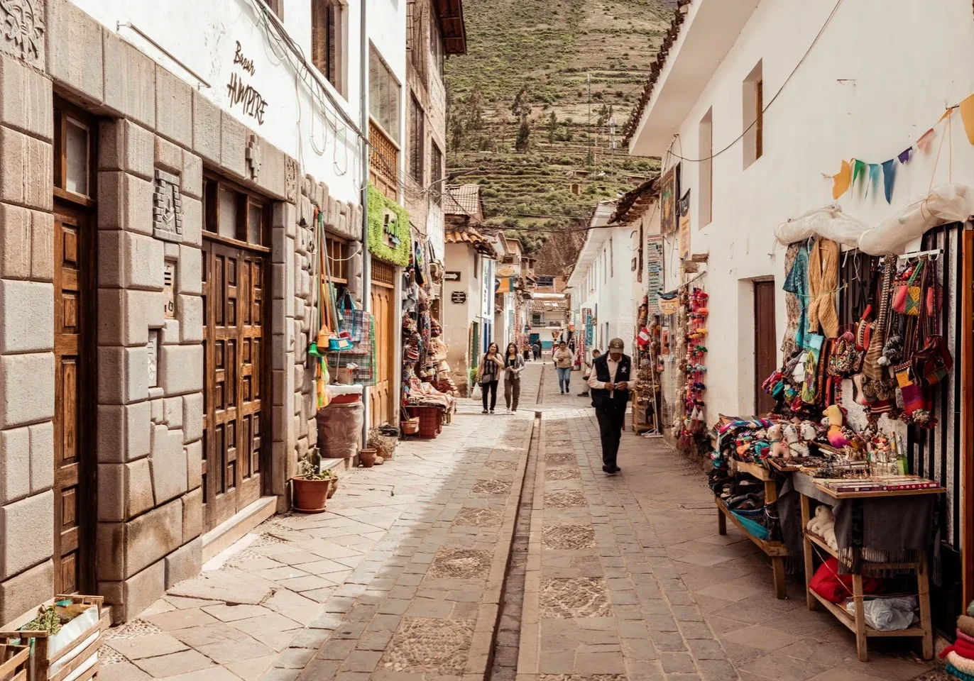 A street with many shops and people walking down it